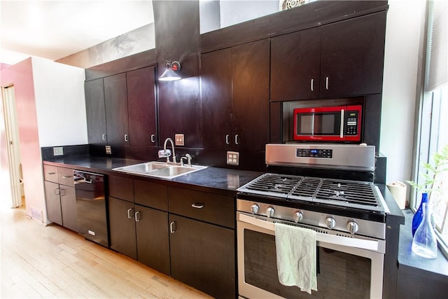 6542 Dalzell Pl, Squirrel Hill, PA 15217 - kitchen with appliances with stainless steel finishes, a sink, dark countertops, light wood-type flooring, and dark brown cabinets