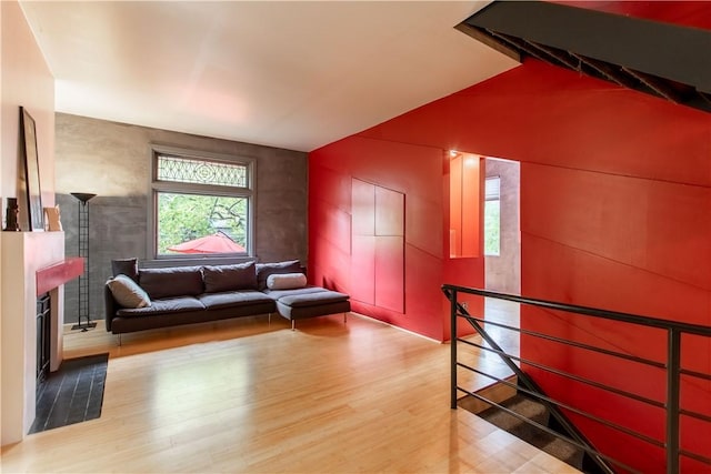 6542 Dalzell Pl, Squirrel Hill, PA 15217 - living area featuring wood finished floors, a fireplace, and lofted ceiling