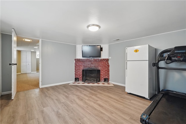 2023 Conlin St, West Mifflin, PA 15122 - unfurnished living room with light wood-style flooring, a brick fireplace, and baseboards
