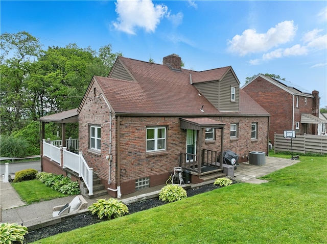 2023 Conlin St, West Mifflin, PA 15122 - rear view of property with central AC, a chimney, brick siding, and roof with shingles