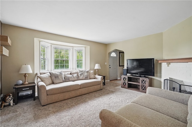 2023 Conlin St, West Mifflin, PA 15122 - carpeted living area featuring arched walkways and a fireplace