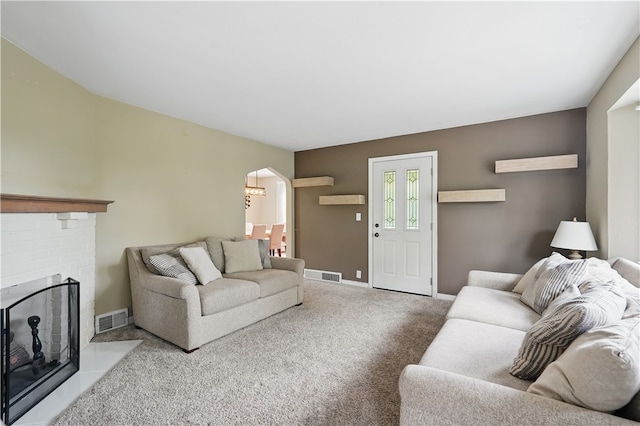 2023 Conlin St, West Mifflin, PA 15122 - living area featuring arched walkways, carpet flooring, baseboards, and a brick fireplace