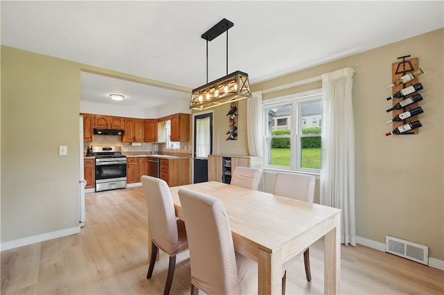 2023 Conlin St, West Mifflin, PA 15122 - dining area with light wood finished floors, a chandelier, and baseboards
