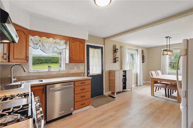 2023 Conlin St, West Mifflin, PA 15122 - kitchen featuring appliances with stainless steel finishes, a sink, exhaust hood, and brown cabinetry