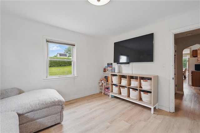 2023 Conlin St, West Mifflin, PA 15122 - living area featuring wood finished floors, arched walkways, and baseboards