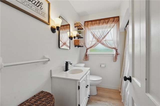 2023 Conlin St, West Mifflin, PA 15122 - full bath with vanity, toilet, wood finished floors, and baseboards