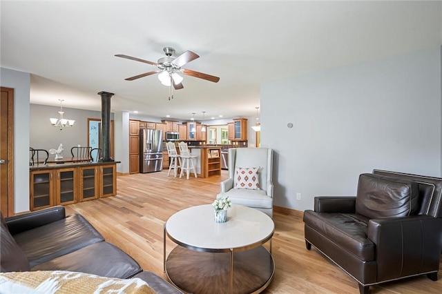 310 Laurel Ln, Leeper, PA 16233 - living room featuring a ceiling fan, light wood-type flooring, and a chandelier