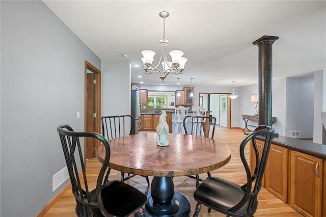 310 Laurel Ln, Leeper, PA 16233 - dining space featuring light wood finished floors, baseboards, and a chandelier