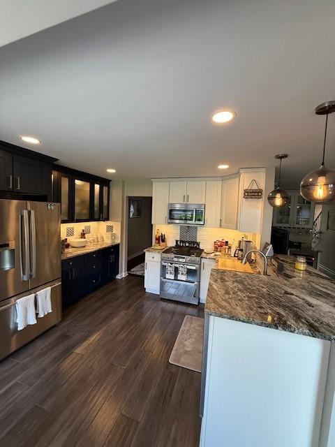 204 Thornberry Cir, Mt Lebanon, PA 15234 - kitchen with appliances with stainless steel finishes, white cabinets, dark wood finished floors, glass insert cabinets, and tasteful backsplash