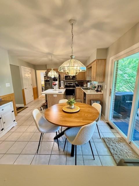 116 Valleycrest Dr, Cecil, PA 15321 - dining area featuring a chandelier, light tile patterned floors, and a wainscoted wall