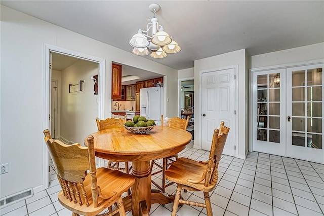 108 Vanita Dr, Moon/Crescent Twp, PA 15108 - dining area featuring a chandelier, light tile patterned floors, and french doors