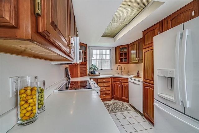108 Vanita Dr, Moon/Crescent Twp, PA 15108 - kitchen featuring white appliances, light countertops, a sink, glass insert cabinets, and brown cabinetry