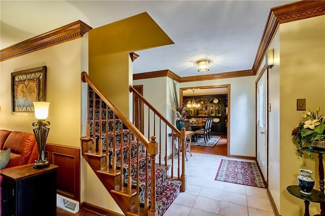 510 Fair Vista Ct, Pine Twp Nal, PA 15090 - foyer with a chandelier, crown molding, stairway, tile patterned floors, and wainscoting