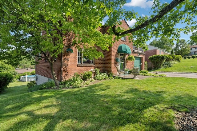 4335 Frank St, Whitehall, PA 15227 - view of front of house featuring a front lawn, driveway, brick siding, and an attached garage