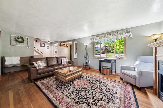4335 Frank St, Whitehall, PA 15227 - living area featuring a fireplace, wood finished floors, stairway, and baseboards