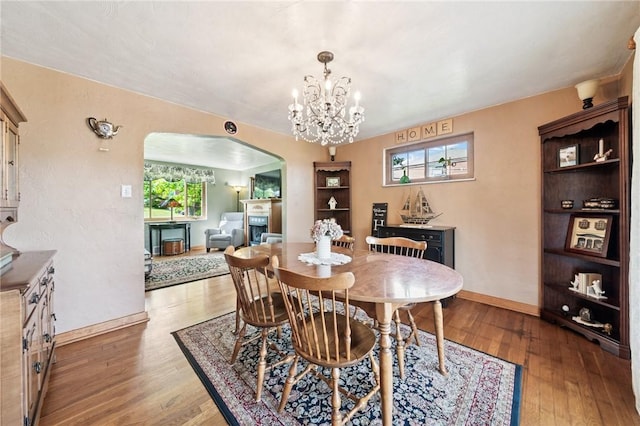 4335 Frank St, Whitehall, PA 15227 - dining room with arched walkways, wood finished floors, and baseboards