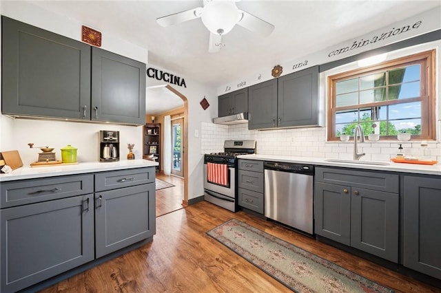 4335 Frank St, Whitehall, PA 15227 - kitchen featuring stainless steel appliances, a sink, under cabinet range hood, wood finished floors, and light countertops