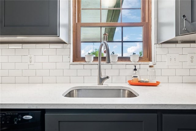 4335 Frank St, Whitehall, PA 15227 - kitchen with black dishwasher, a sink, light stone countertops, backsplash, and gray cabinetry
