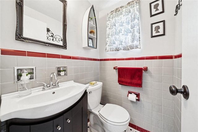 4335 Frank St, Whitehall, PA 15227 - bathroom with tile walls, toilet, vanity, and a wainscoted wall