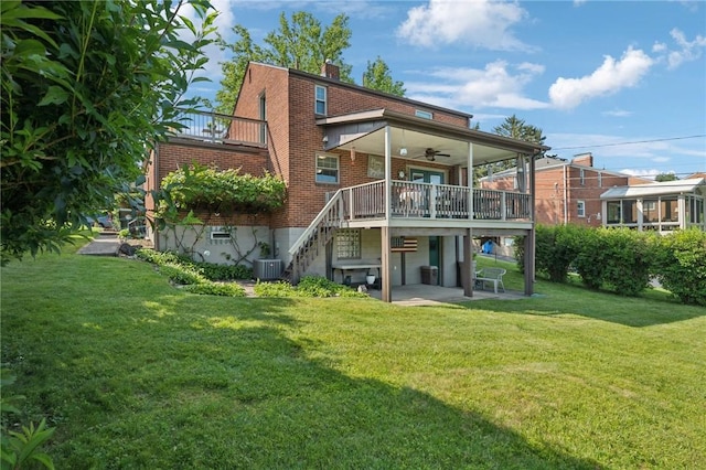4335 Frank St, Whitehall, PA 15227 - rear view of property featuring ceiling fan, central air condition unit, brick siding, a patio area, and a lawn