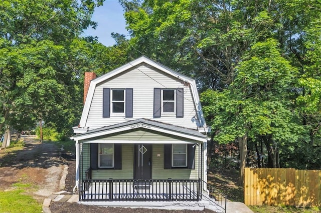8536 Pershing St, Penn Hills, PA 15235 - dutch colonial featuring a gambrel roof, covered porch, and a chimney