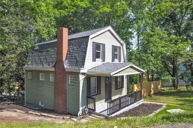 8536 Pershing St, Penn Hills, PA 15235 - view of front of home featuring a shingled roof, a porch, a chimney, and a gambrel roof