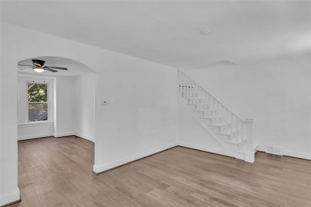 8536 Pershing St, Penn Hills, PA 15235 - empty room with stairway, ceiling fan, wood finished floors, and baseboards