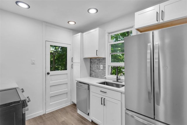 8536 Pershing St, Penn Hills, PA 15235 - kitchen with stainless steel appliances, a sink, light wood finished floors, recessed lighting, and light countertops