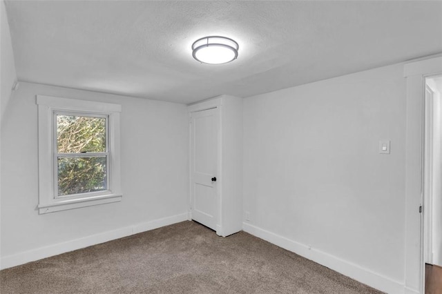 8536 Pershing St, Penn Hills, PA 15235 - spare room with carpet flooring, a textured ceiling, and baseboards