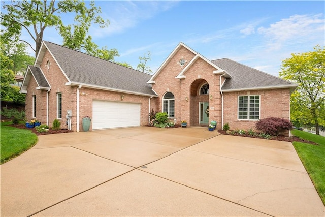 221 Red Oak Dr, Peters Twp, PA 15317 - traditional-style home featuring brick siding, concrete driveway, a garage, roof with shingles, and a front lawn