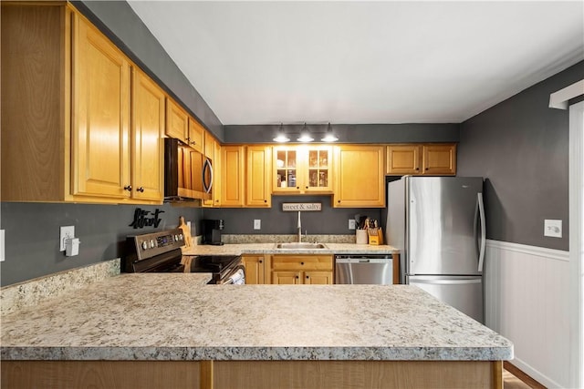 25 Rolling Rd, Cranberry Twp, PA 16066 - kitchen featuring appliances with stainless steel finishes, light countertops, a sink, glass insert cabinets, and wainscoting