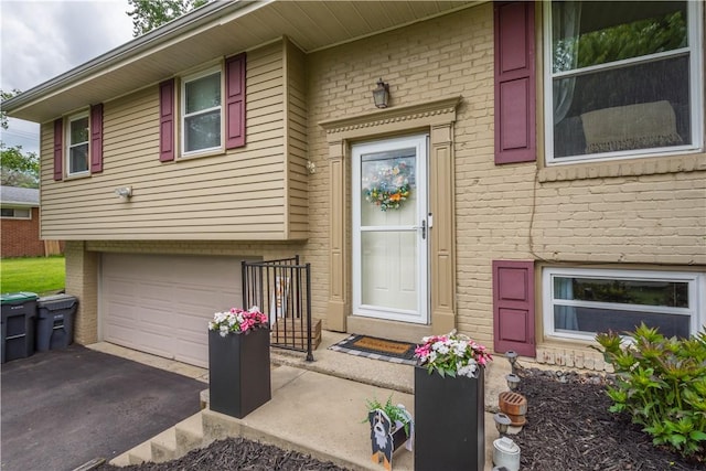 25 Rolling Rd, Cranberry Twp, PA 16066 - doorway to property featuring brick siding, a garage, and asphalt driveway