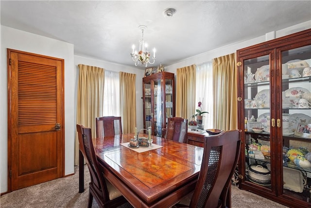 711 Ascension Dr W, West Mifflin, PA 15122 - dining area featuring carpet, a chandelier, and healthy amount of natural light