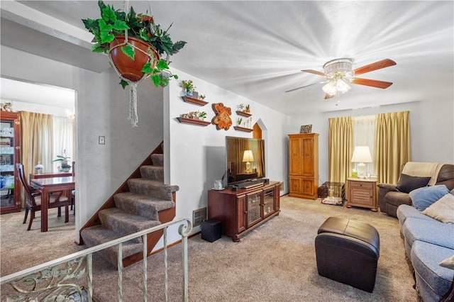 711 Ascension Dr W, West Mifflin, PA 15122 - living area featuring light carpet, stairs, a ceiling fan, and arched walkways