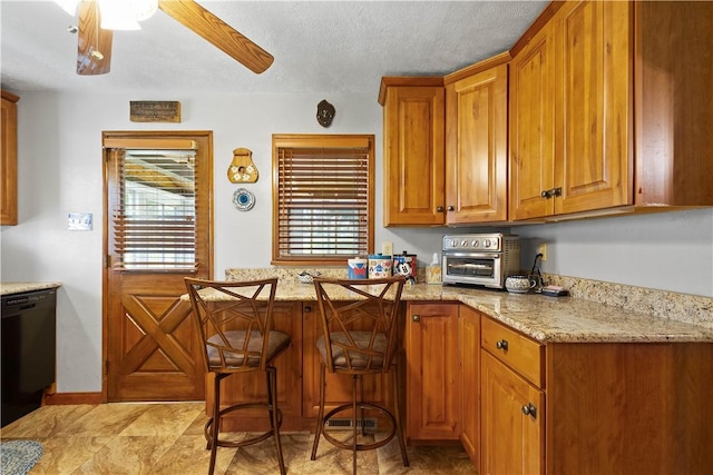 711 Ascension Dr W, West Mifflin, PA 15122 - kitchen featuring black dishwasher, brown cabinets, light stone countertops, ceiling fan, and a textured ceiling