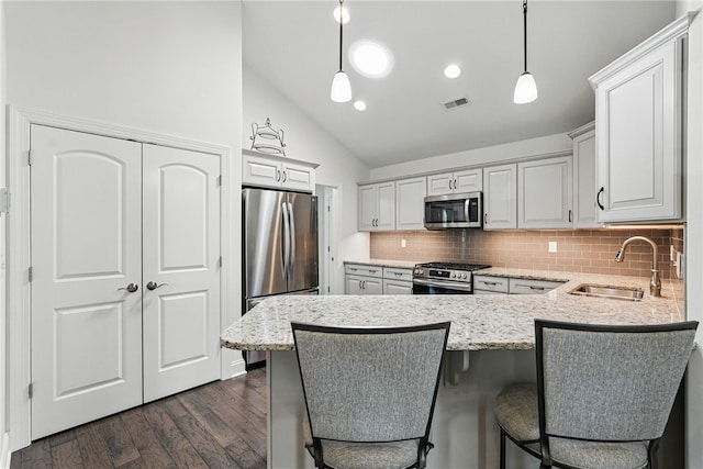 342 Saddlebrook Rd, West Deer, PA 15044 - kitchen with appliances with stainless steel finishes, a sink, a peninsula, tasteful backsplash, and light stone counters
