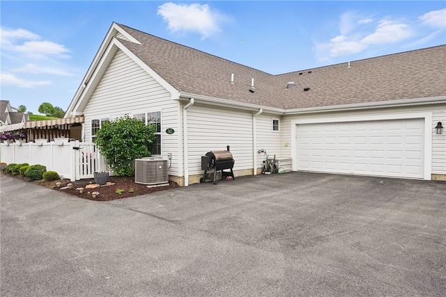 342 Saddlebrook Rd, West Deer, PA 15044 - view of property exterior with cooling unit, an attached garage, a shingled roof, and asphalt driveway