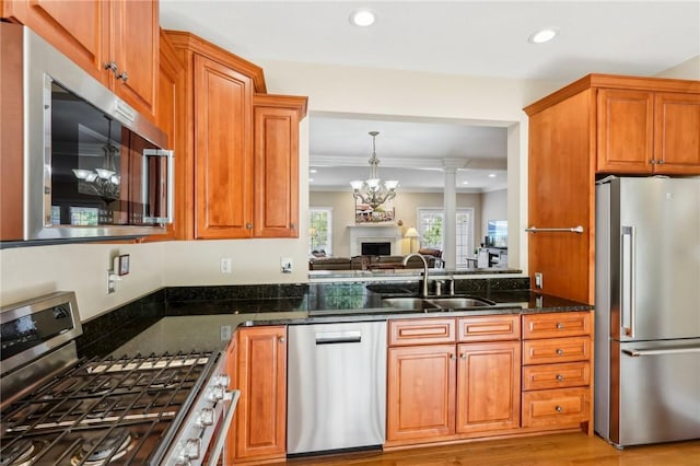 91 Shenot Rd, Marshall, PA 15090 - kitchen featuring stainless steel appliances, a sink, recessed lighting, dark stone countertops, and a fireplace