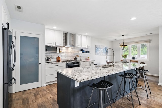 123 Ashley Hill Dr, Mccandless, PA 15090 - kitchen with a sink, stainless steel appliances, wall chimney range hood, wood finished floors, and recessed lighting