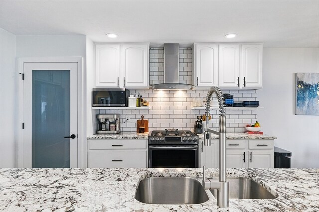 123 Ashley Hill Dr, Mccandless, PA 15090 - kitchen featuring wall chimney exhaust hood, gas range, a sink, stainless steel microwave, and light stone countertops