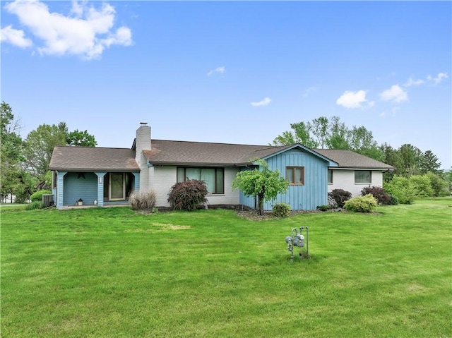 829 Hecla Rd, Mount Pleasant Twp Wml, PA 15666 - view of front of house featuring a chimney, a front yard, board and batten siding, and roof with shingles