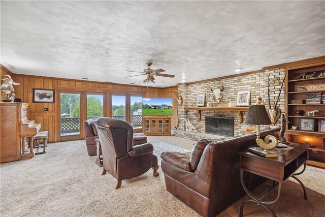 829 Hecla Rd, Mount Pleasant Twp Wml, PA 15666 - living area with carpet floors, a ceiling fan, wood walls, a brick fireplace, and crown molding