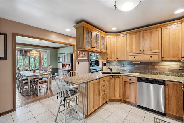 829 Hecla Rd, Mount Pleasant Twp Wml, PA 15666 - kitchen with dishwasher, light tile patterned floors, a sink, a peninsula, and backsplash