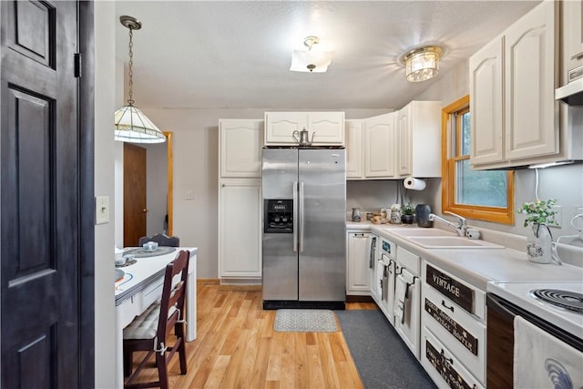 829 Hecla Rd, Mount Pleasant Twp Wml, PA 15666 - kitchen with stainless steel fridge, a sink, white cabinets, light wood-style floors, and light countertops
