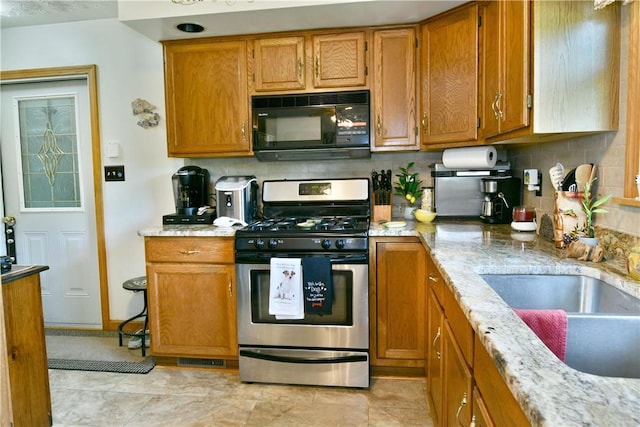 3062 Longview Rd, Hermitage, PA 16148 - kitchen featuring black microwave, stainless steel range with gas stovetop, and brown cabinets