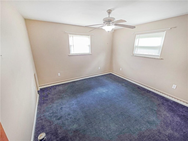 2828 School St, Harmony Twp Bea, PA 15003 - empty room featuring plenty of natural light, a ceiling fan, dark carpet, and baseboards