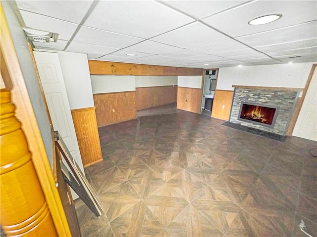 2828 School St, Harmony Twp Bea, PA 15003 - finished below grade area featuring a paneled ceiling, wood walls, wainscoting, and a fireplace with flush hearth