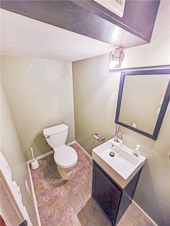2828 School St, Harmony Twp Bea, PA 15003 - half bathroom featuring toilet, vanity, and baseboards