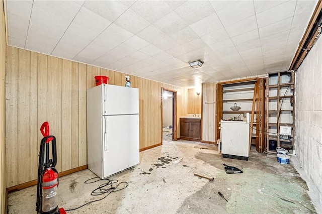 308 Cypress St, Rostraver, PA 15089 - finished below grade area featuring freestanding refrigerator, fridge, wood walls, and a sink