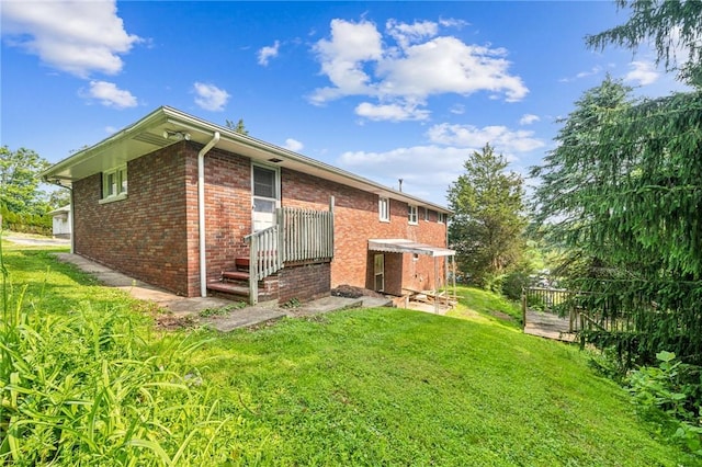 308 Cypress St, Rostraver, PA 15089 - rear view of house with a lawn and brick siding